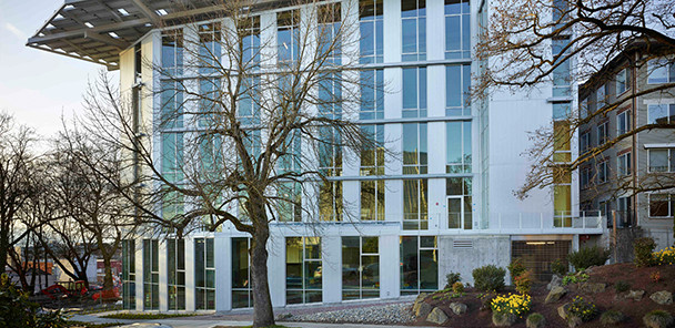 Exterior of the Bullitt Center, a white and glass building with 6 stories and a large roof overhang.